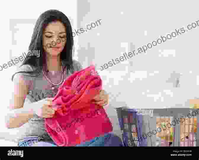 A Woman Folding Laundry, Pensive Expression On Her Face Hand Wash Cold: Care Instructions For An Ordinary Life